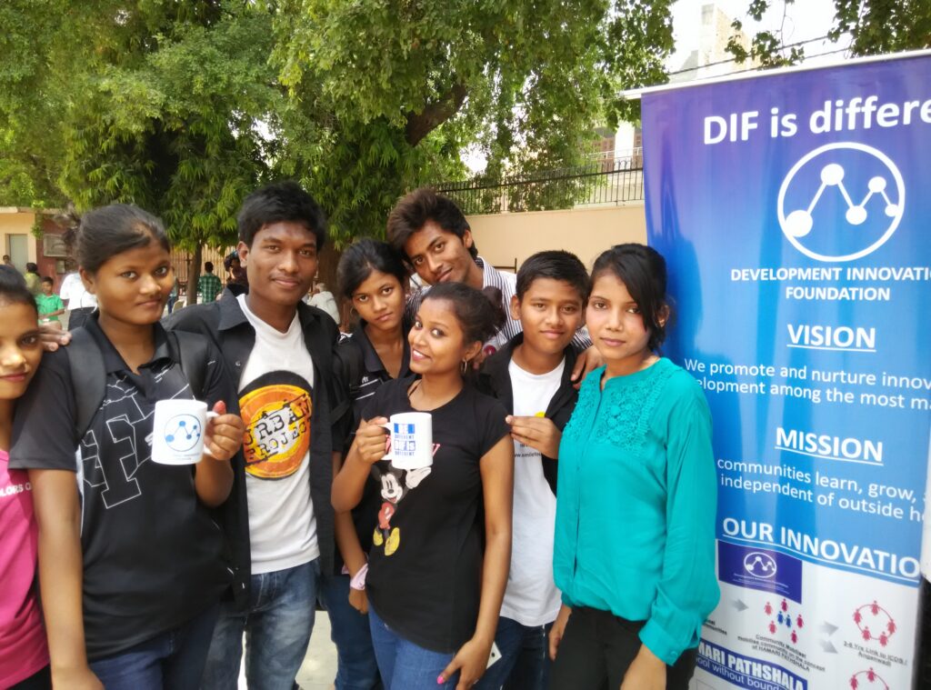 Young people stand near blue DIF poster